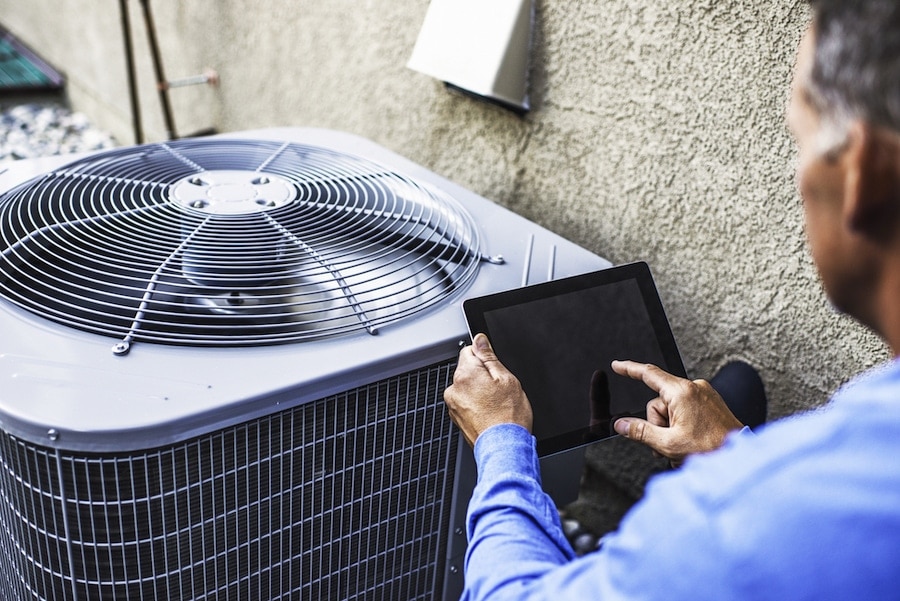 HVAC technician fixing air conditioner.