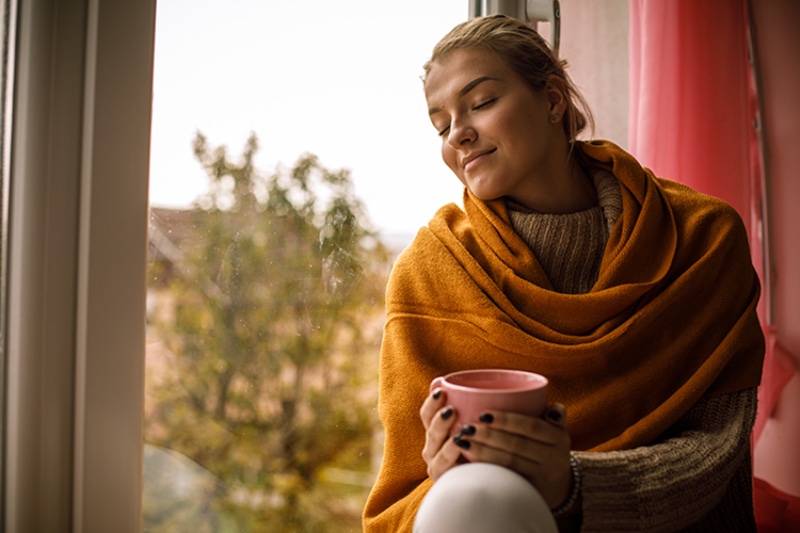 The Basics of Winter Indoor Air Quality - Cozy Woman Indoors.