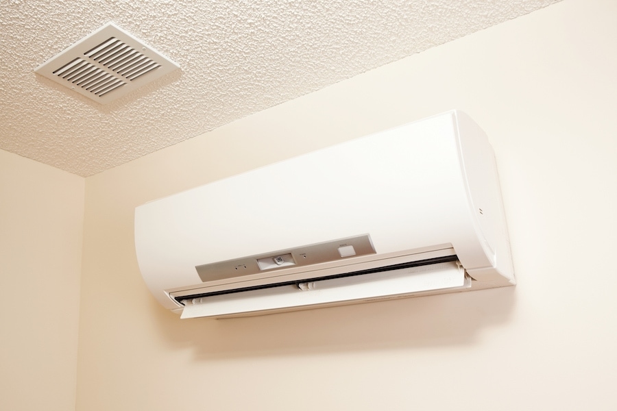 A wall-mount mini-split heating and air conditioning unit installed in a new house. A modern heat pump